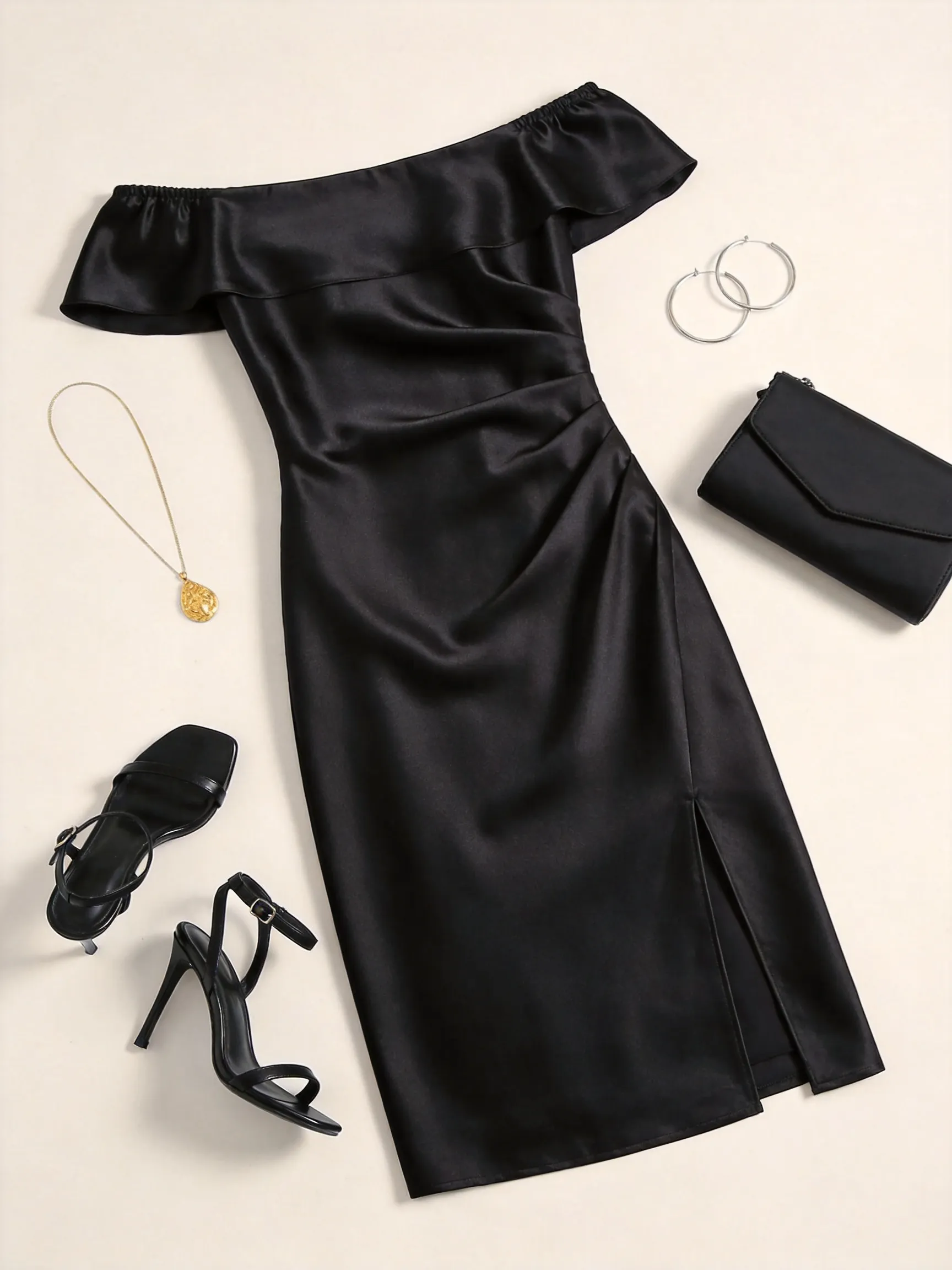 Flat lay fashion outfit, no human. An elegant off-the-shoulder black satin midi dress fully spread out with its side slit visible, paired with black high-heel sandals, a minimalist black clutch bag, delicate gold pendant necklace, and hoop earrings. All items neatly laid flat to show their full shapes on a clean off-white background. Studio lighting, top-down view.