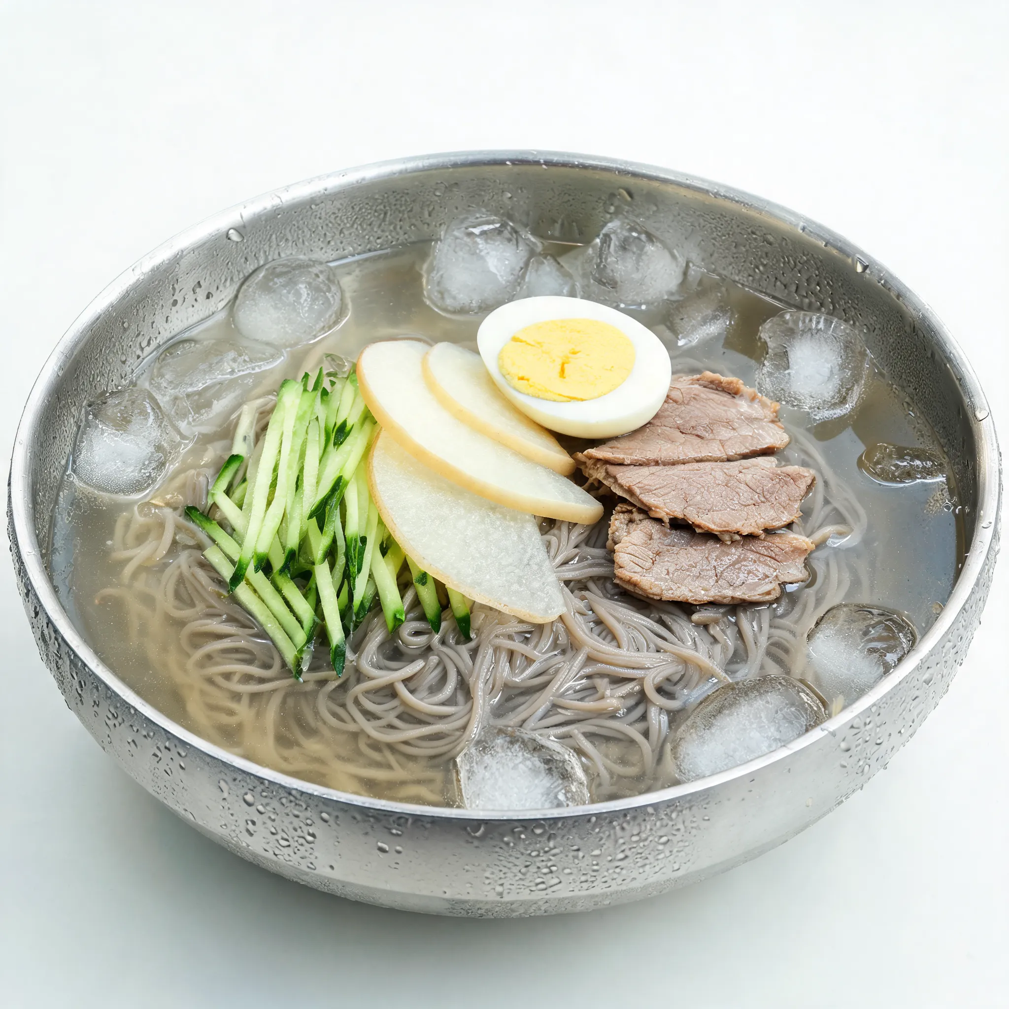 Korean cold noodles (naengmyeon), stainless steel bowl, icy broth with floating ice cubes, thin chewy noodles, sliced cucumber, pear, boiled egg, beef slices, refreshing summer food style, condensation on bowl, clean minimal restaurant menu photography, commercial advertising image, ultra realistic, 8K, fresh and appetizing look