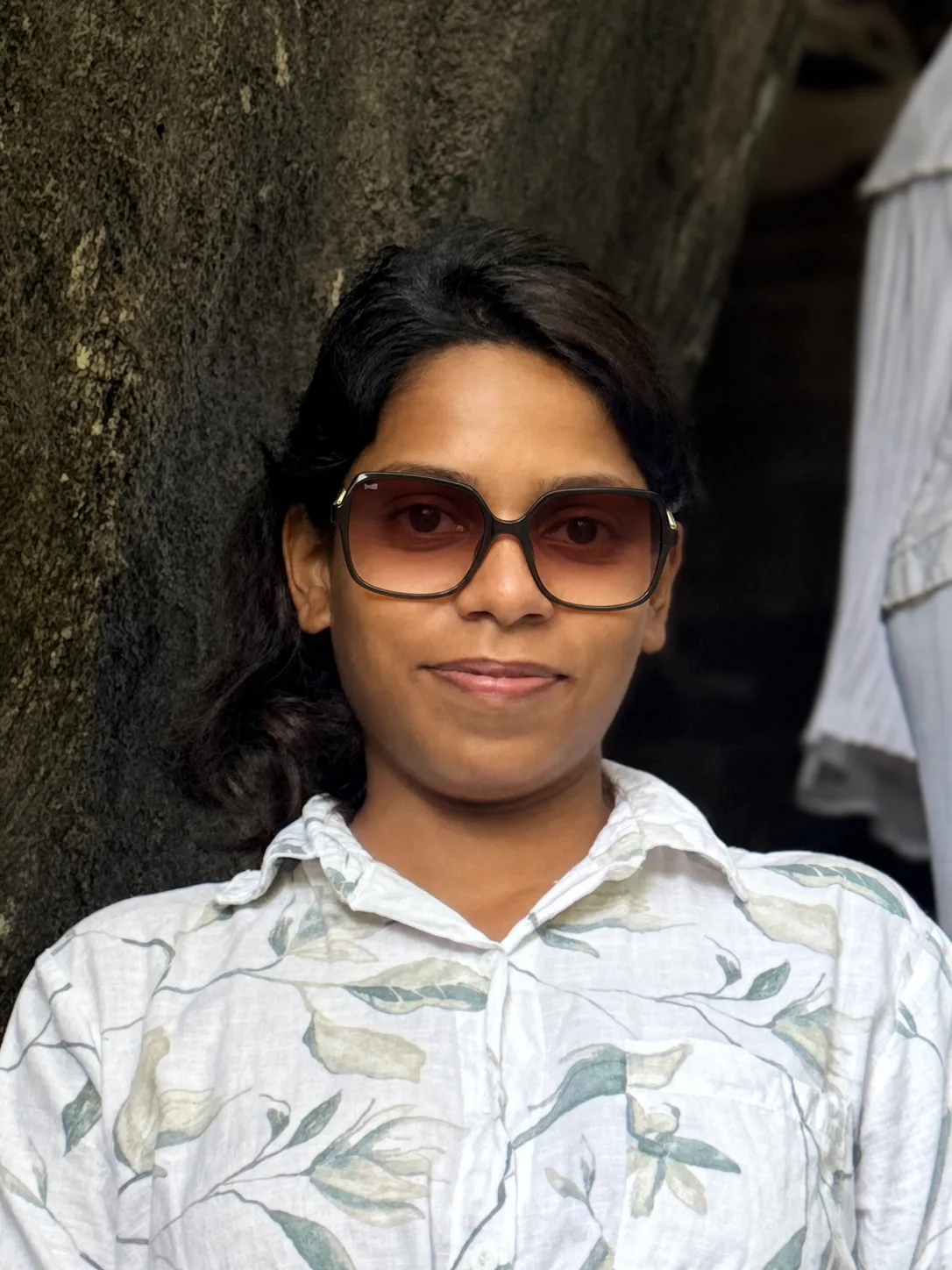 Analyze the uploaded person’s face, head orientation, and lighting conditions. Generate a 3×3 grid showing the same person wearing nine different sunglasses styles. Place each pair naturally on the face with accurate scale, perspective, and alignment to the head angle. Ensure the frames interact realistically with the nose, ears, and hair while preserving the person’s identity and facial features. Match lighting and shadows so the sunglasses appear naturally worn in the original photo. Each grid cell should display a different frame style such as aviator, square, round,, rectangular, rimless, sport, Clubmasters (Browline), Oval Sunglasses and wayfarer.