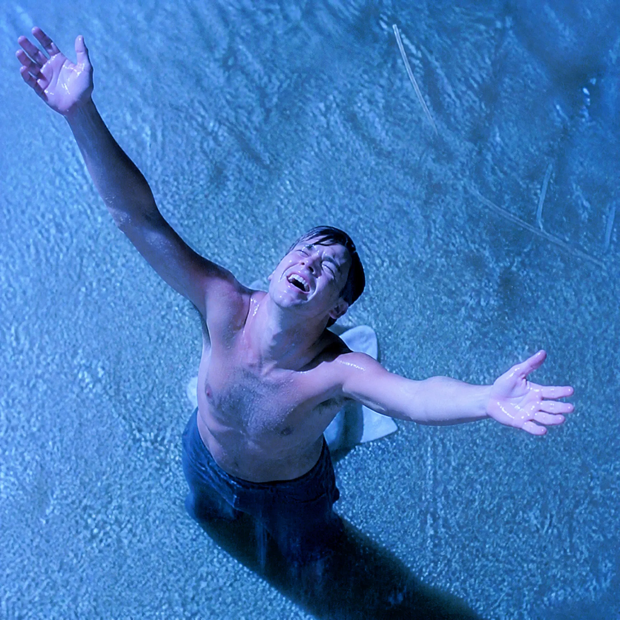 Arms outstretched after escape in The Shawshank Redemption