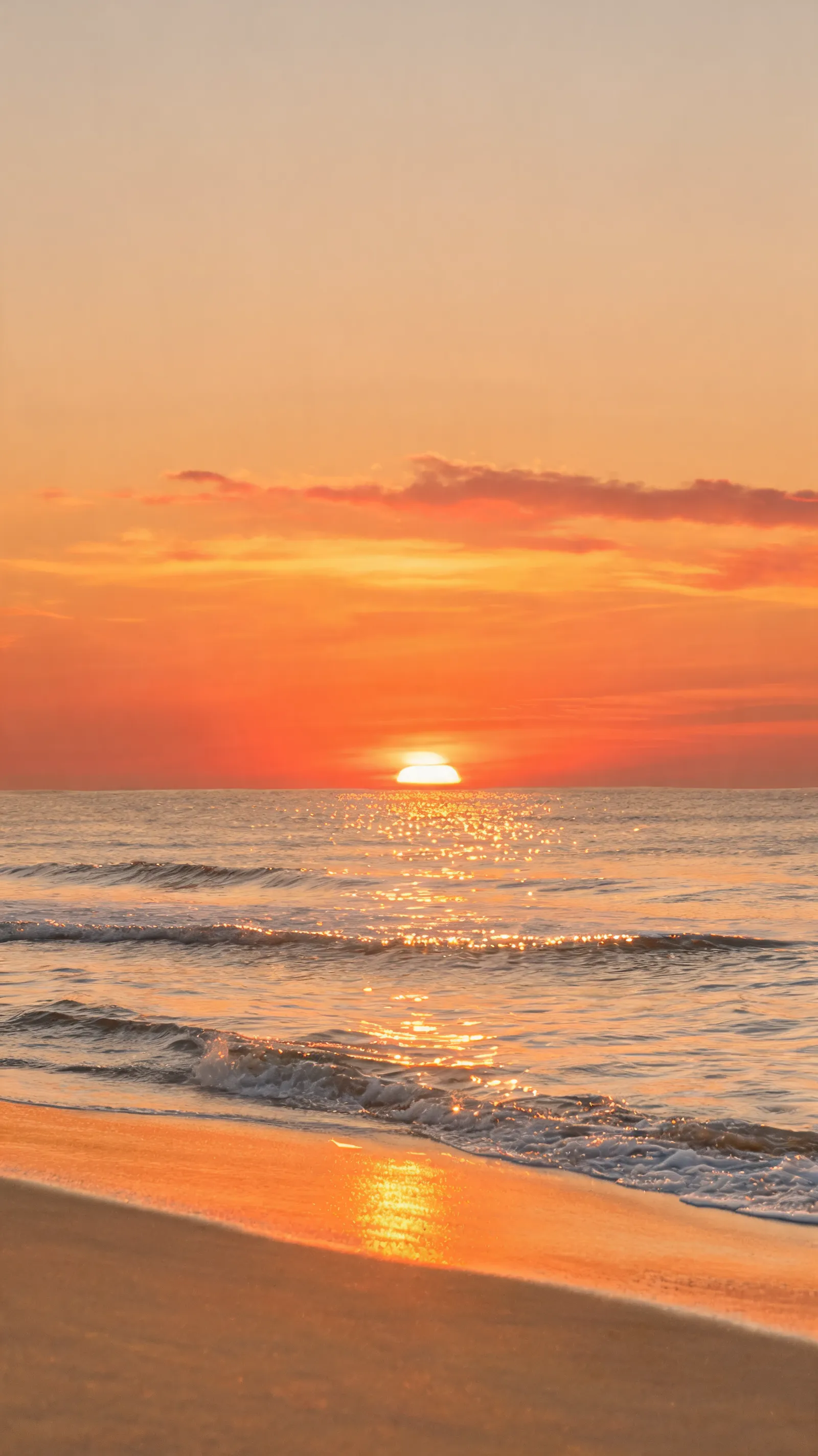 A serene beach with golden sunlight reflecting on the waves, the sky showing a gradient of orange and red