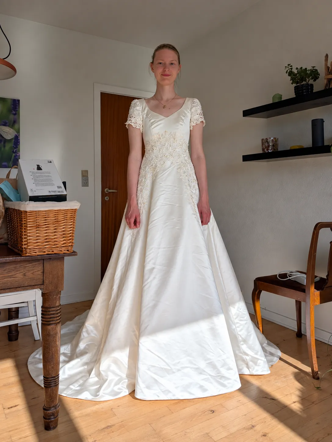 Will you make three pictures from the uploaded picture. 1) Add a waist length gathered vail over the ponytail. 2) Add a knee length single layerd vail with a lace edge over the ponytail. 3) Change the ponytail to a bun and add a cathedral length vail with lace edge. The vail ends 10 cm before the train of the dress